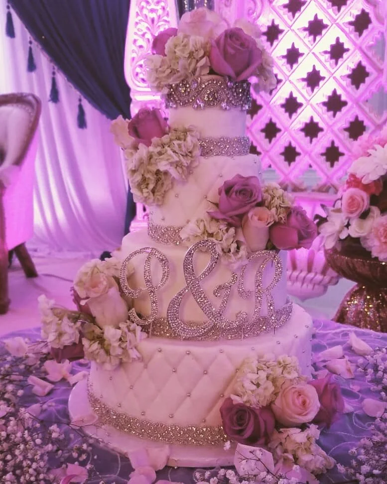 An elegant pink floral wedding cake by AMR Catering