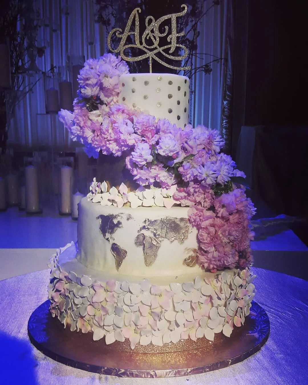 A pink-toned wedding cake by AMR Catering finished with soft buttercream and floral detailing.