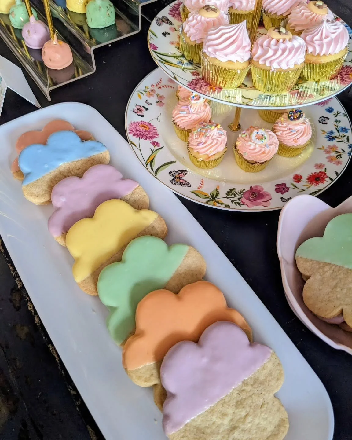 Rainbow of colorful frosted cupcakes